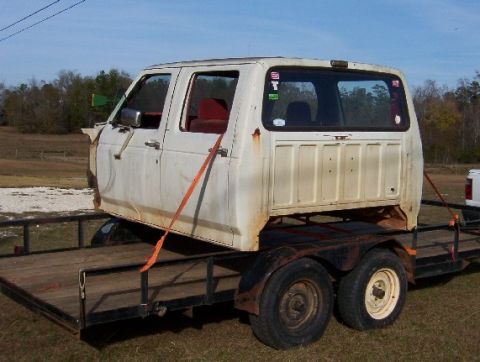 1992 Lincoln Custom - A detached truck cab is secured with straps to a trailer, ready for transport.