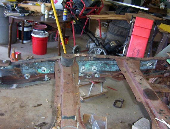 rusted vehicle frame with bolts and rubber mounts