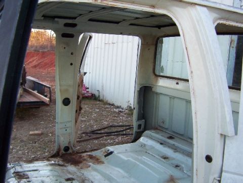 1992 Lincoln Custom - The interior of a pickup truck cab is shown, stripped down to the bare metal with visible rust.