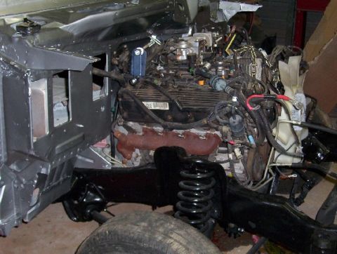 1992 Lincoln Custom - The engine bay and front suspension of a vehicle are shown, with the body panels removed.