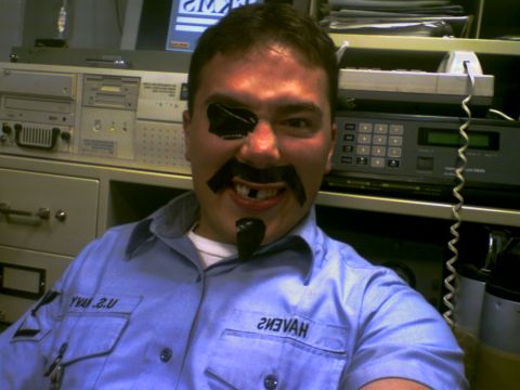 2001 Ford Crown Victoria - A man poses for a photo with a makeshift pirate costume, including an eyepatch and fake facial hair.