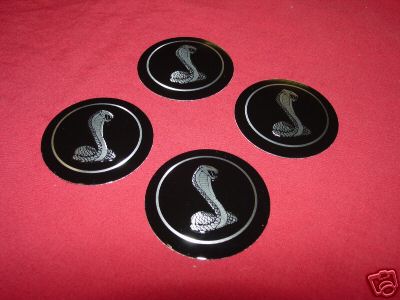 1978 Ford Mustang II - Set of four Cobra snake emblems, likely for a Ford vehicle.