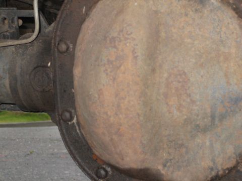 1995 Ford Bronco - Close-up of a heavily rusted differential housing, suggesting a need for repair or replacement.