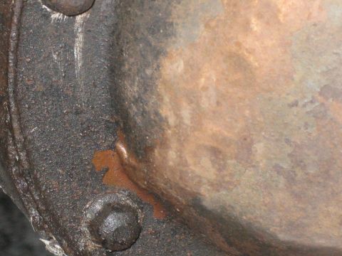 1995 Ford Bronco - Detail of a differential cover, showing rust and oil stains.