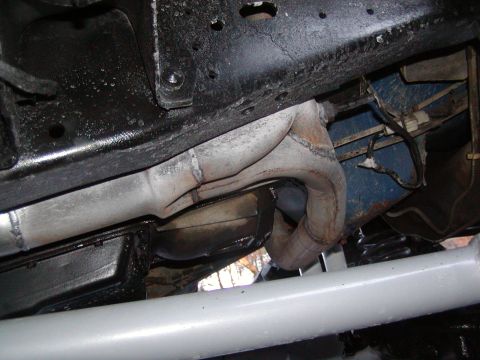1991 Ford Bronco - Underside view of a vehicle's exhaust system and frame components.