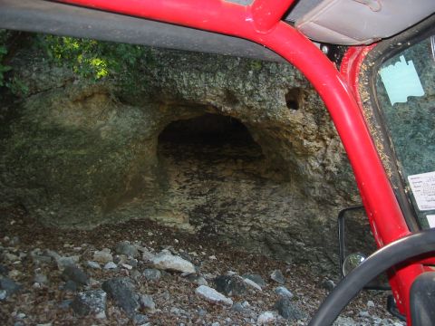 1996 Ford Bronco - The photo shows a cave entrance in a rocky area, viewed from the interior of a vehicle.