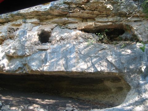 1996 Ford Bronco - A natural rock formation with openings that resemble small caves or shelters.