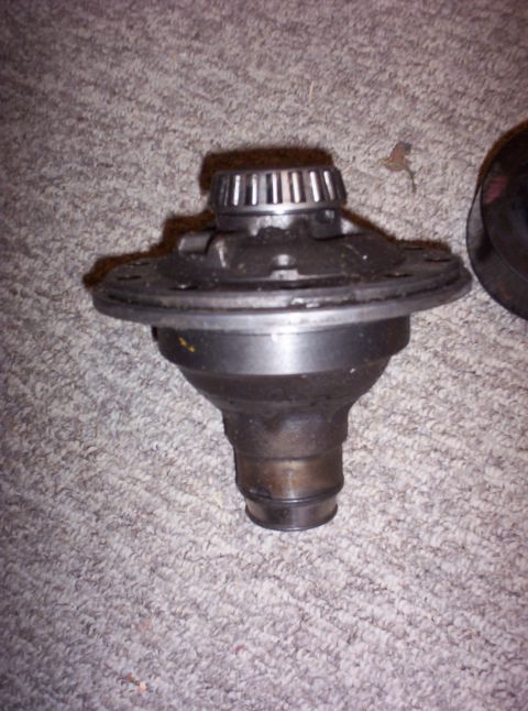 1987 Jeep Cherokee - Differential carrier with a bearing race visible on top, resting on a carpeted surface.