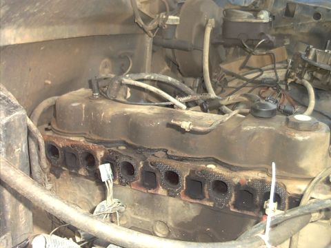 1985 Ford Bronco - Close-up view of an engine bay, focusing on the exhaust manifold and valve cover.