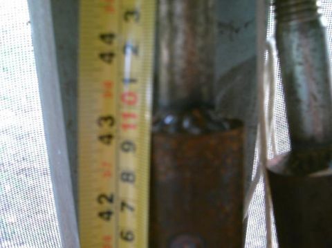 1986 Ford Bronco - A close-up of a metal pole with a tape measure, showing measurements and weld details.