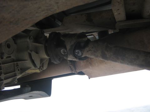 1995 Ford Bronco - Close-up of the vehicle's drivetrain components, showing the driveshaft connected to the differential.
