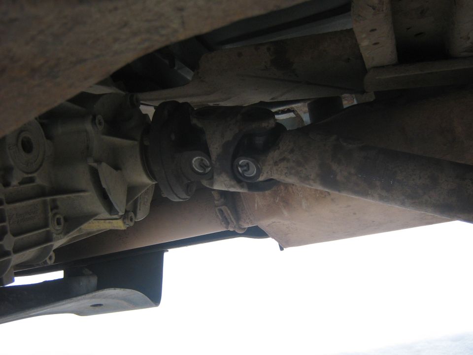 Underside view of a vehicle's driveshaft and differential assembly