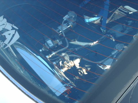 1995 Ford Probe - Custom air suspension components and wiring are visible through the rear window of a vehicle.