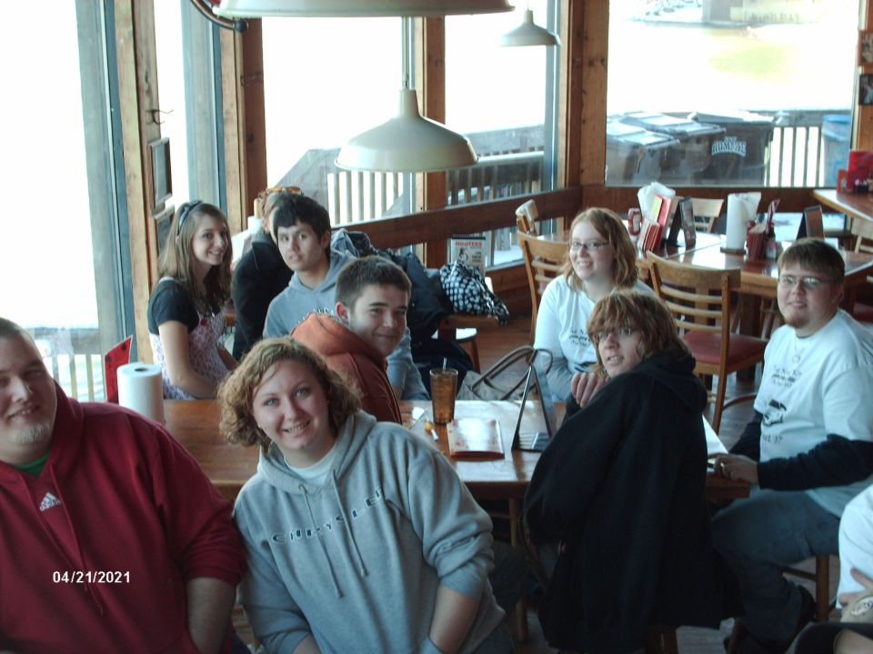 Group of friends gathered at tables inside a restaurant