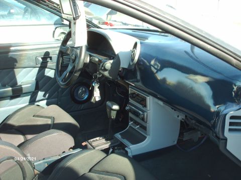 1995 Ford Probe - Interior view of a car, aftermarket steering wheel and custom door paneling.