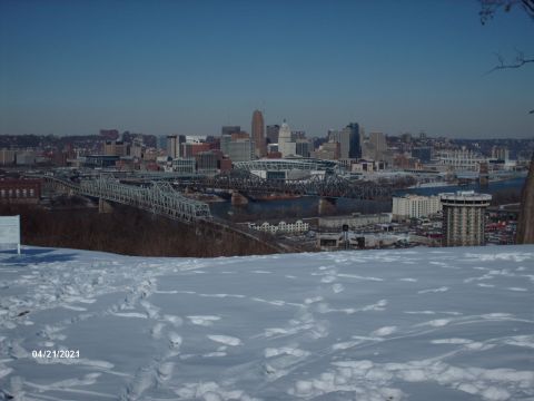 1995 Ford Probe - A winter scene shows a city skyline in the distance, with a river and bridges visible.