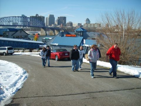 1995 Ford Probe - A red convertible is parked near a Hooters restaurant with a city skyline in the background.