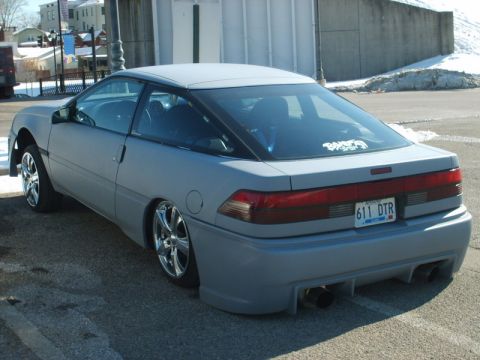 1995 Ford Probe - This gray coupe features a custom body kit and chrome wheels, with a license plate reading 611 DTR.
