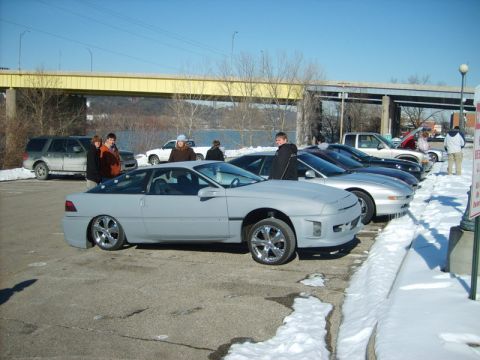 1995 Ford Probe - Gray 1995 Ford Probe coupe parked in a snowy lot with other vehicles and people nearby.