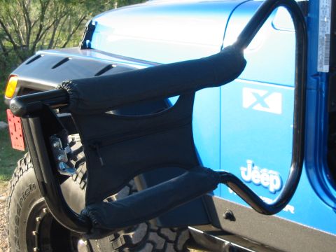 1996 Ford Bronco - A blue Jeep Wrangler is shown from the side, equipped with a black roll cage and padded grab handles.