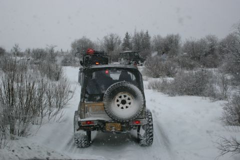 2003 Jeep TJ - Several Jeep TJs navigate a snow-covered trail during winter conditions.