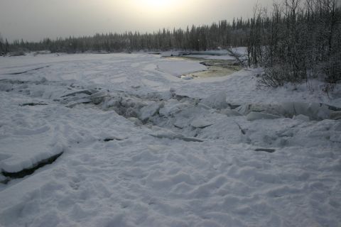 2003 Jeep TJ - The river is choked with ice, with open water visible in the distance.