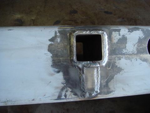 1996 Ford Bronco - A metal part shows a freshly welded square opening, indicating custom fabrication work.