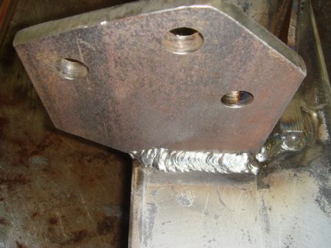 1996 Ford Bronco - Close-up of a welded metal bracket, showing the weld seam and bolt holes.