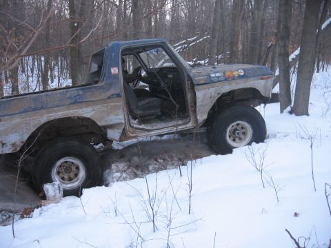 1979 Ford Bronco - This 1978 Ford Bronco is stuck in the snow with its driver's door open.