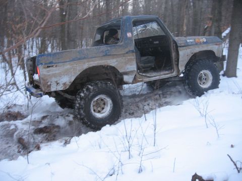 1979 Ford Bronco - This 1978 Ford Bronco is navigating a snowy, wooded trail with its doors open.