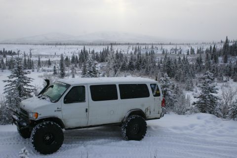 2003 Jeep TJ - A modified van sits in a snow-covered wilderness, ready for off-road adventure.