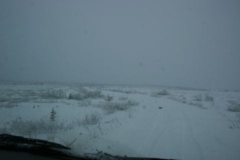 2003 Jeep TJ - A desolate, snow-covered landscape with a faint dirt road visible, suggesting a remote location.