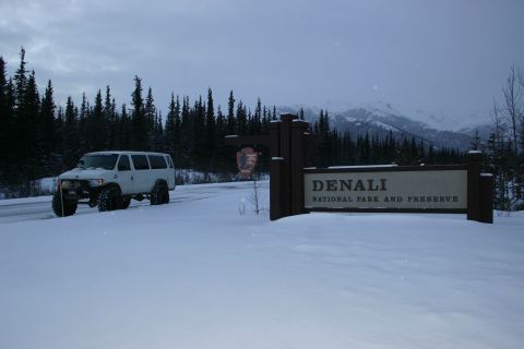 2003 Jeep TJ - A white van drives through a snowy landscape near the Denali National Park and Preserve entrance sign.