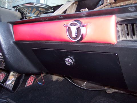 1972 Ford Ranchero - Close-up of a car's dashboard, a bull emblem and a speaker.
