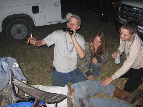 1974 Ford F-100 - People gather around trucks at night, with one person looking through binoculars.