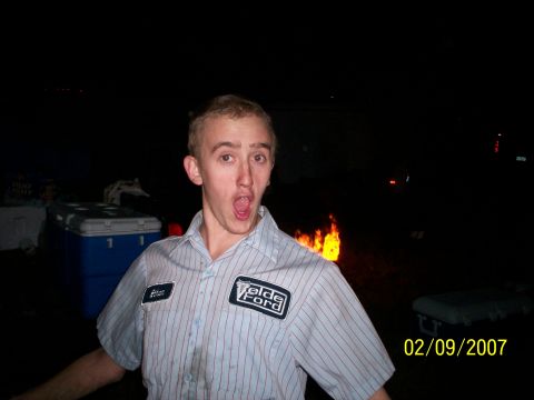1974 Ford F-100 - Man in a Velde Ford shirt poses in front of a bonfire on February 9, 2007.