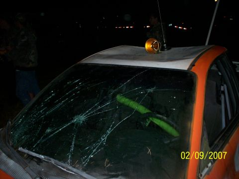1974 Ford F-100 - A damaged truck cab is seen at night with a broken windshield and an emergency light on its roof.