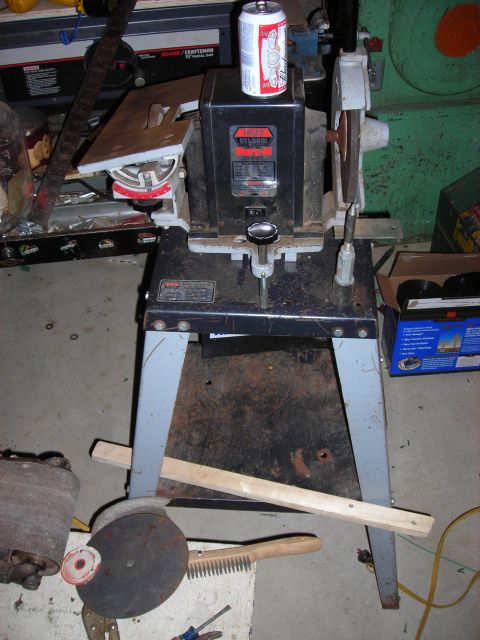 1995 Ford Bronco - A collection of shop tools, including a bench grinder and sharpening equipment, are arranged on a stand.