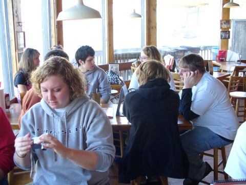 1991 Ford Probe - A group of people are gathered around tables inside a casual dining establishment.