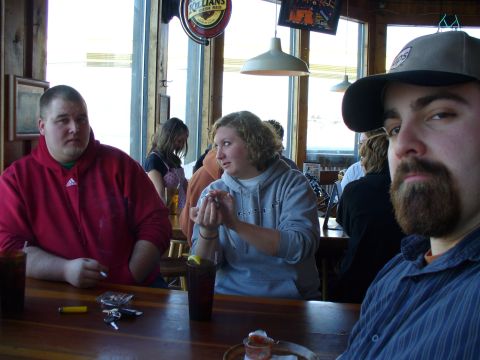 1991 Ford Probe - Several people are gathered at a bar, some with drinks in front of them.