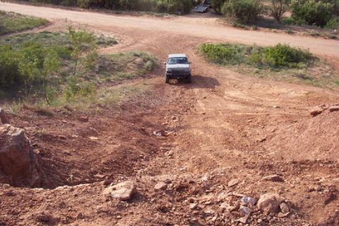 1995 Ford Bronco - 1995 Ford Bronco navigating an off-road trail.