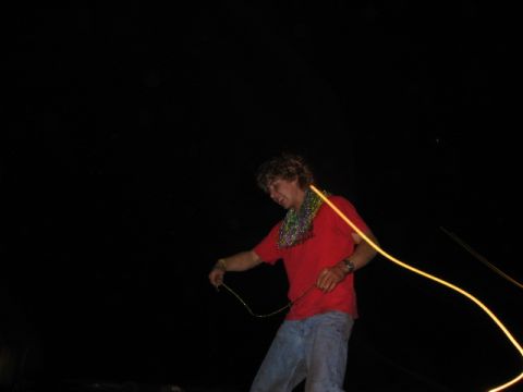 1974 Ford F-100 - A person is seen holding a string with a light trail, against a dark background.