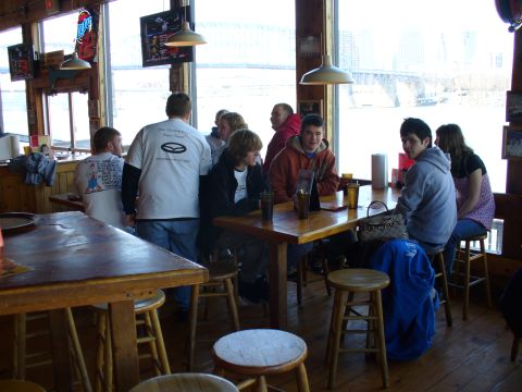 1991 Ford Probe - A group of people are seated at tables inside a casual dining establishment.