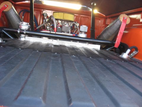 1974 Ford F-100 - Custom engine bay and bed of an orange truck, aftermarket parts and modifications.