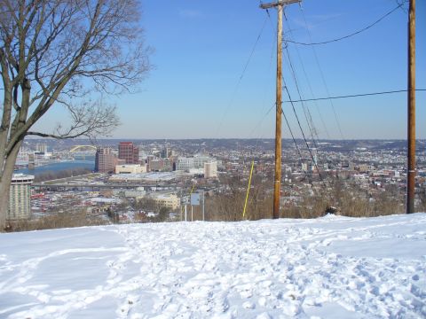 1991 Ford Probe - Winter scene overlooking a city with a river and bridge visible.