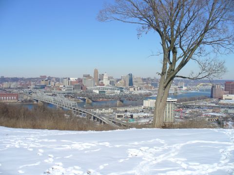 1991 Ford Probe - Winter view of a city skyline with bridges and a river, seen from a snow-covered hill.