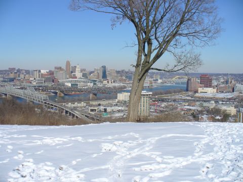 1991 Ford Probe - A winter scene overlooks a city skyline with bridges spanning a river.