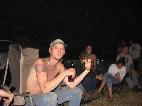 1974 Ford F-100 - People gathered around a campsite at night, enjoying drinks and conversation.