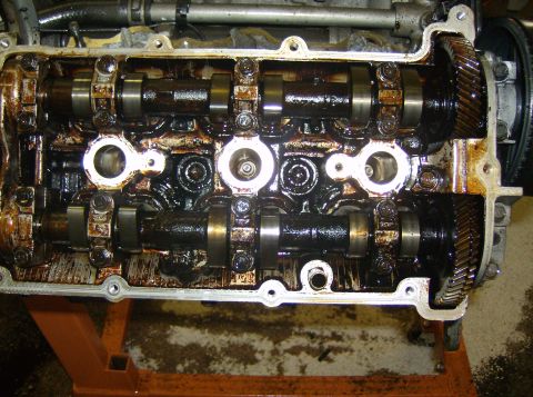1996 Ford Probe - Close-up view of an engine's internal components, including camshafts and gears, with the valve cover removed.