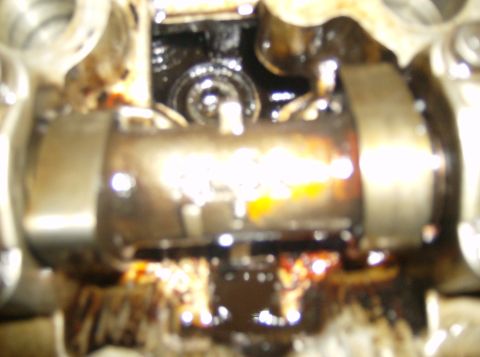 1996 Ford Probe - Engine internal components, likely a valve train, covered in oil.